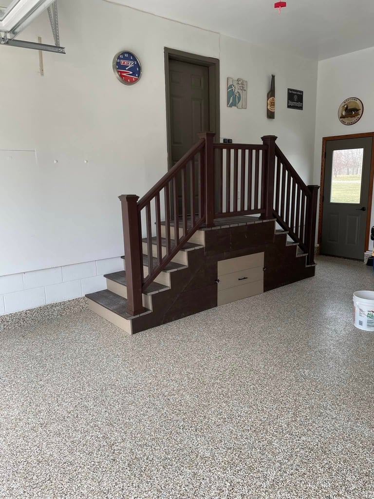 Dark wooden dog training stairs with railings in a garage-style room with white walls and concrete flooring