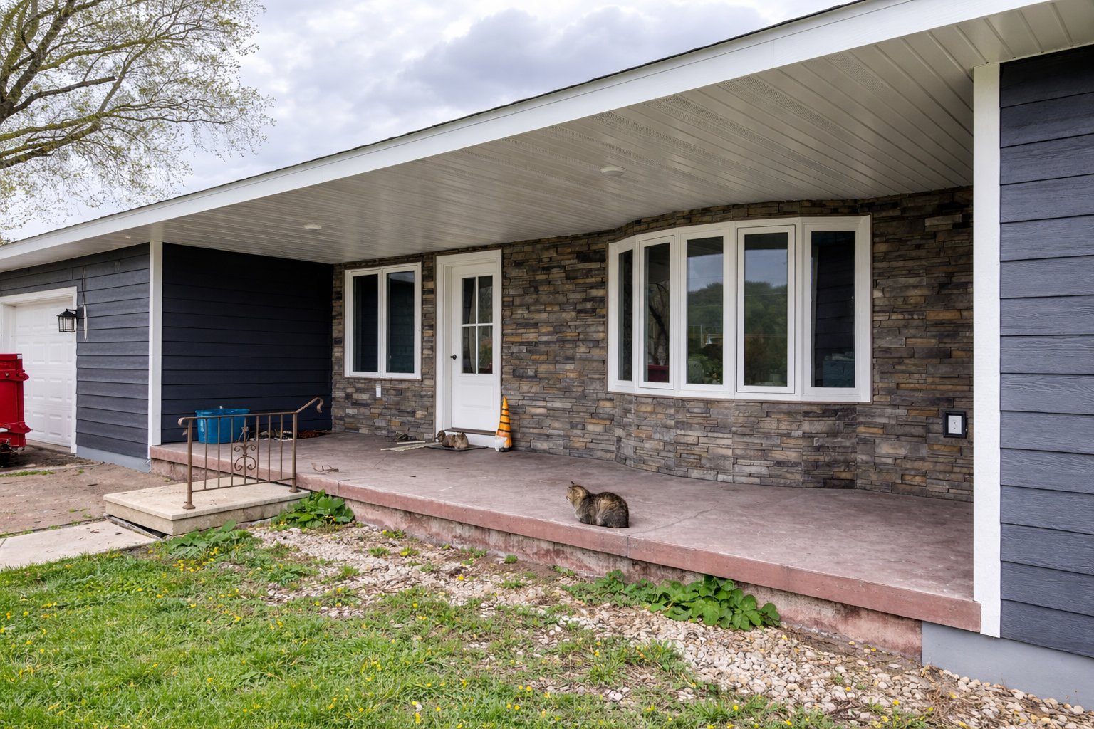 Modern brick house with covered patio and attached garage built by Sendelbach Builders